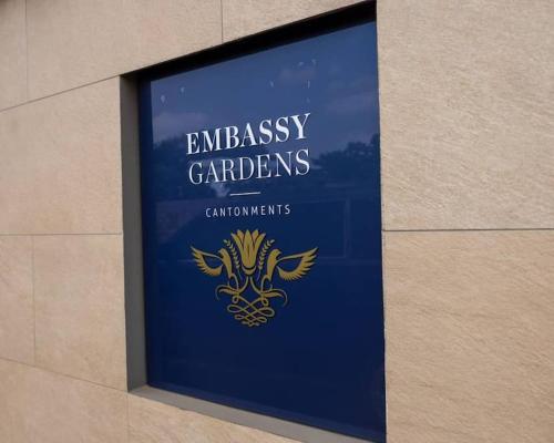 a sign for the entrance to the emissary gardeniusesiuses at Cosy 1 Bedroom @Embassy Gardens in Cantonments