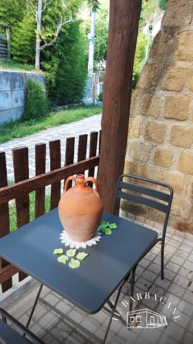 a vase sitting on top of a table with a chair at Il Barbacane in Bacoli