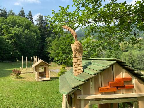 a cat on the roof of a wooden house at Children Cottage Župkov - in gorgeous valley in Župkov