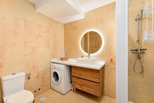 a bathroom with a sink and a washing machine at Duquesa Regent 2435 Wonderful seaviews duplex in Manilva