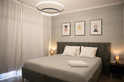 a bedroom with a large white bed with two lamps at צימר אדל - Zimmer Adel in Yavneʼel