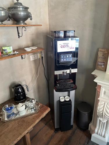 a kitchen with a coffee maker and a stove at B&B Saint-Sauveur Bruges in Bruges