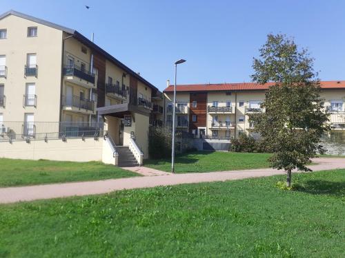 an apartment building with a sidewalk next to a grass field at Navili Grand Apartment in Trezzano sul Naviglio