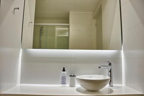 a bathroom with a sink and a mirror at Babel Arcos in Buenos Aires