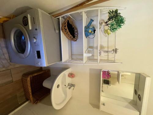 a bathroom with a toilet and a sink and a mirror at Batroun chalet in front of the pool - Batrouna Park Resort 