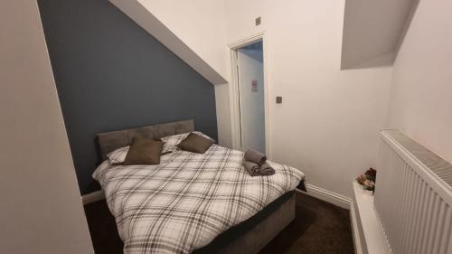 a small bedroom with a bed with two pillows on it at Willesden J Guest Home 4 in London