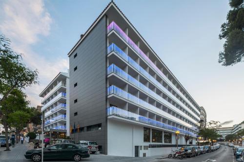 a large building with a pointed roof on a street at Hotel Best San Francisco in Salou