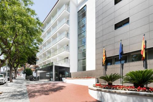 un bâtiment avec drapeaux devant lui dans l'établissement Hotel Best San Francisco, à Salou