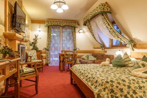 a bedroom with two beds and a table and chairs at Leśny Dworek Zakopane in Zakopane