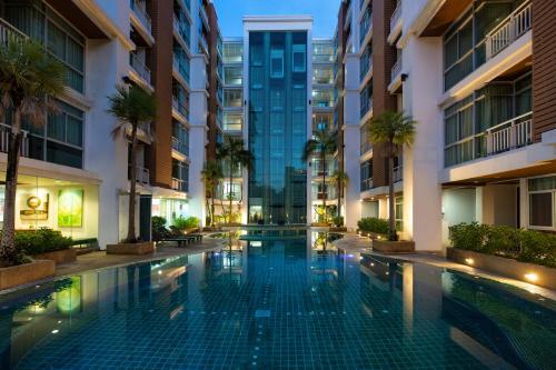a swimming pool in the middle of a building at iCheck inn Residences Patong in Patong Beach