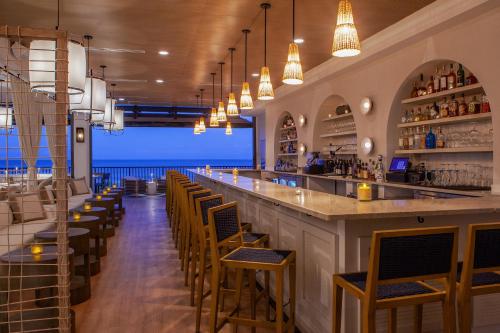 a bar with chairs and a view of the ocean at Ashore Resort & Beach Club in Ocean City