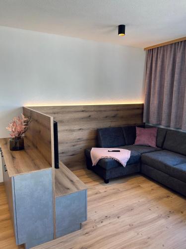 a living room with a couch and a table at Apart Eder in Schwendau