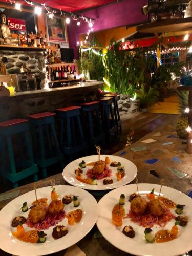 two plates of food on a table in a restaurant at El Refugio La Brisa del Diablo in Valle Hornito