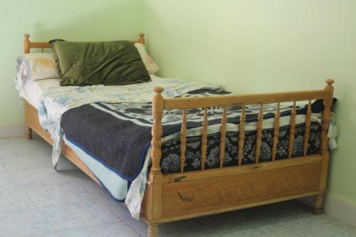 a bedroom with a wooden bed with aicter at auberge le SIRWA SALAM in Ouarzazate