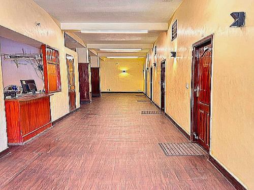 an empty hallway of a building with a long corridor at Flagship Le Pondy Paradise in Puducherry