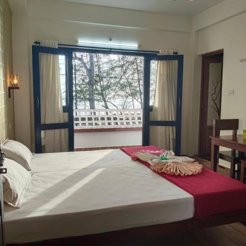 a large bed in a room with a window at Cherai Ocean View Home in Cherai Beach