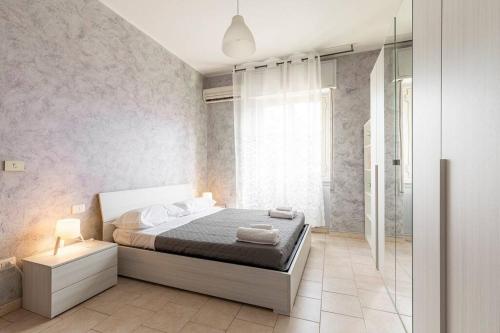a bedroom with a bed and a glass shower at [Milano Fiera] Total Relax Pero in Pero