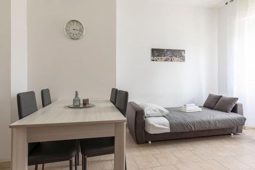 a dining room with a table and a bed at [Milano Fiera] Total Relax Pero in Pero