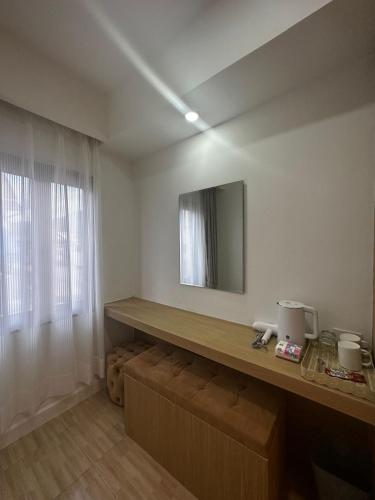 a room with a counter and a mirror on the wall at Midnight Blue Guesthouse in Luang Prabang