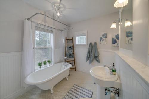 a white bathroom with a tub and a sink at Spacious Loon Lake Retreat Dock and Mtn Views! in Loon Lake