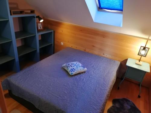 a bedroom with a bed with a pillow on it at Beautiful 1-Bed Apartment in Fuzine with lake view in Fužine