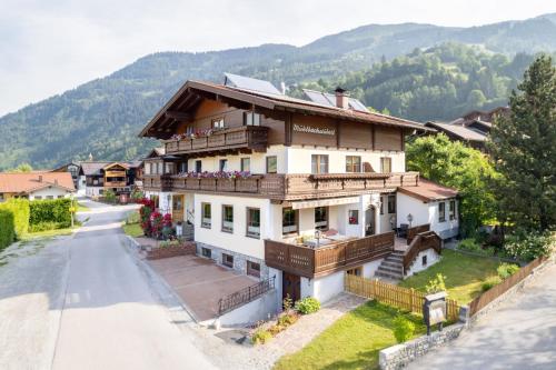 a house in the mountains with a road at am mühlbach - einfach sein in Dorfgastein