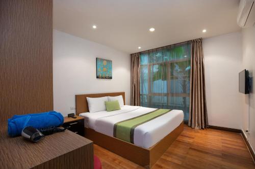 a hotel room with a bed and a window at iCheck inn Residences Patong in Patong Beach