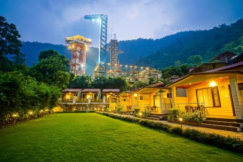 a row of houses with a factory in the background at The Grand Shiva Resort and Spa in Rishīkesh
