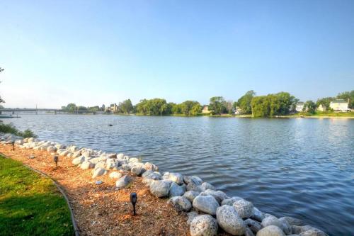 a row of rocks on the shore of a lake at Riverfront Retreat! Water front and dog friendly! in Two Rivers
