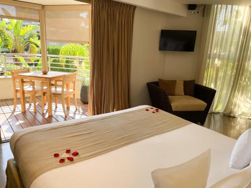 a hotel room with a bed and a balcony at Cannes Villa St Barth in Cannes