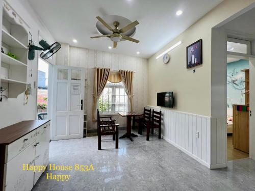 a kitchen with a table and a ceiling fan at Căn Happy in Vung Tau