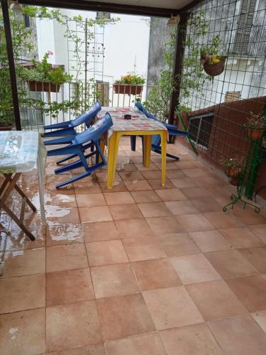 a patio with a table and chairs on a tiled floor at Villa Carolina in Fara San Martino