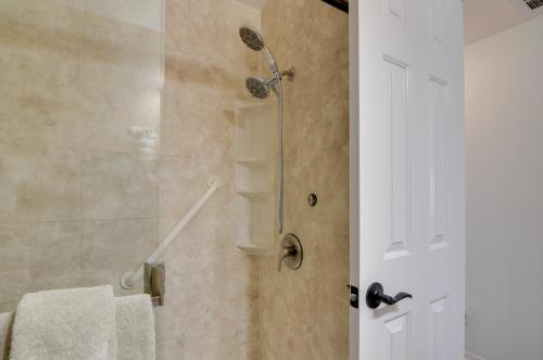 a bathroom with a shower with a glass door at Picturesque Page Home Near Lake Powell and Hiking! in Page