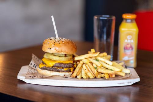 a cheeseburger and french fries on a plate at ibis Santiago Estacion Central in Santiago