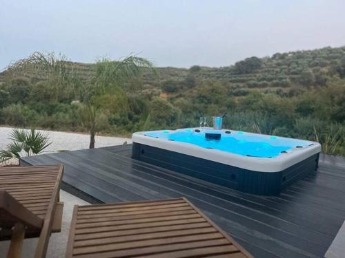 a hot tub sitting on top of a wooden deck at Ek Ornelakis, Luxury Country House with Jacuzzi in Chania Town