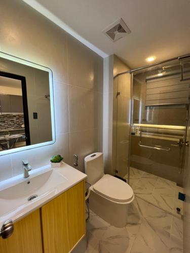 a bathroom with a toilet and a sink and a shower at Luxury Cabin Near Fields Avenue in Angeles