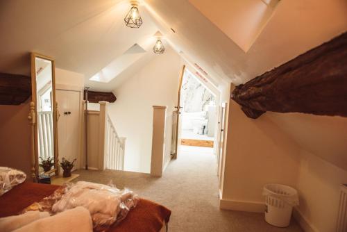 a attic room with a bed and a hallway at The Granary in Montgomery