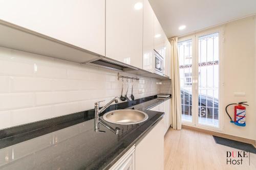 a kitchen with a sink and a window at Marqués de Vadillo2 Apartments in Madrid