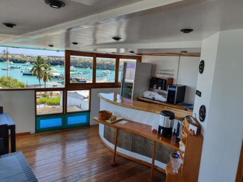 a kitchen with a view of a marina through the windows at Casa Ocean Pier in Puerto Ayora