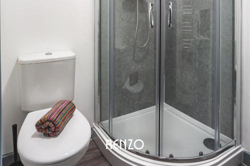 a bathroom with a toilet and a shower at Vibrant 1-bed Apartment in Derby by Renzo, Central Location! in Derby