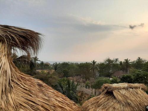 a view of a thatched roof of a village at La Isla Bonita - Departamento en la Punta in Puerto Escondido