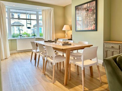a dining room with a wooden table and chairs at Central Townhouse with free off road parking and garden in York
