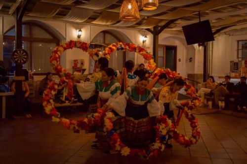 a group of people in a wreath of flowers at Viajero Quito Hostel in Quito