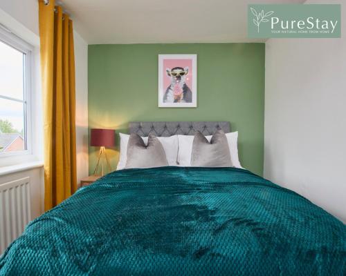a bedroom with a green bed with a picture of a dog at Stunning 6-Bedroom House in Nantwich with Parking & Free Wi-Fi by PureStay Short Lets in Nantwich