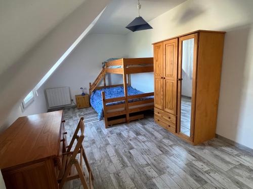 a bedroom with a bunk bed and a desk at Brittany Beach Home Gavres - Morbihan in Porh-Guer