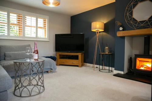 a living room with a couch and a television at 4 Bed House Sleeps 9 - Parking Garden Bbq Wifi in Yeadon