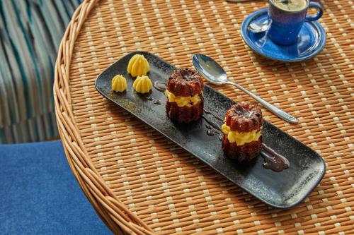 a plate with three pieces of food on a table at Hotel Indigo Bordeaux Centre Chartrons by IHG in Bordeaux