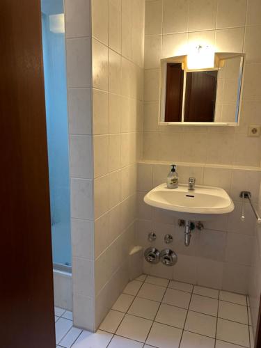 a bathroom with a sink and a mirror at Vallendarer Stübchen in Vallendar