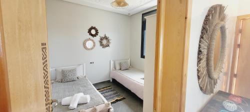 a room with a bed and a couch in it at Magnifique villa face à l'océan in Tiznit
