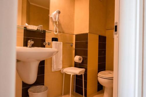 a bathroom with a sink and a toilet at Hotel Terme Pellegrini in Montecatini Terme
